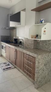 a kitchen with a sink and a counter top at Downtown apartment in Sinop