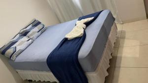 a bed with a blue blanket on top of it at Downtown apartment in Sinop