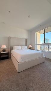 a white bedroom with a large bed and a large window at Volar Luxurious #328 in Los Angeles +67 photos