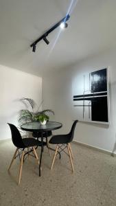 a dining room with a table and two chairs at Cabrero Beach 1212 in Cartagena de Indias