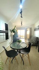 a living room with a table and chairs and a couch at Cabrero Beach 1212 in Cartagena de Indias
