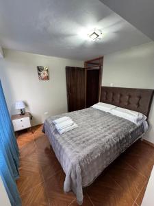 a bedroom with a large bed in a room at Santa Ana Home Cusco in Cusco