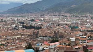 a view of a city with buildings and mountains at Santa Ana Home Cusco in Cusco