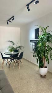 a living room with a table and potted plants at Cabrero Beach 1212 in Cartagena de Indias