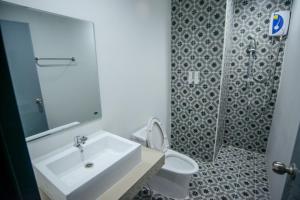 a bathroom with a sink and a toilet and a shower at PJ Loft Hotel in Ban Khok Krathin +5 photos