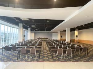 a large room with rows of chairs and a stage at Luxury Inn Arion Hotel in Jakarta