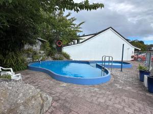 a swimming pool in a yard with at Chelmswood Motel Taupo in Taupo