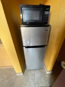 a microwave sitting on top of a refrigerator at Shangri La Motel in Ocala