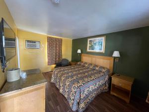 a hotel room with a bed and a television at Shangri La Motel in Ocala