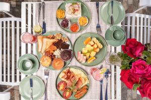 a table with plates of food on it at Villa Rosaria - Framed by Nature, Finished with Luxury in Beragala +35 photos