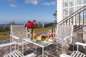a table with a plate of food and a vase of flowers at Villa Rosaria - Framed by Nature, Finished with Luxury in Beragala