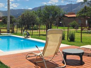 a chair and a table next to a pool at La Jocunda - Cortaderas - Piscu Yaco in Cortaderas