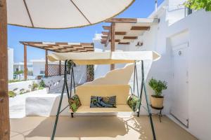 a chair under a canopy on a balcony at Casa de Flores 2 in Plaka Milou