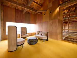 a living room with two chairs and a table at ONCRI-Karatsu おんくり唐津 in Karatsu