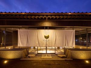 a stage with a white curtain on the side of a building at ONCRI-Karatsu おんくり唐津 in Karatsu