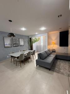 a living room with a couch and a table at Sublime Mognos Apartment - Bosque Saúde in Cuiabá +30 photos