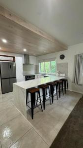 a large kitchen with a large marble counter in a room at Gosling Grove Hideaway in Turangi
