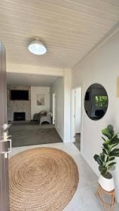 a living room with a large rug on the floor at Gosling Grove Hideaway in Turangi