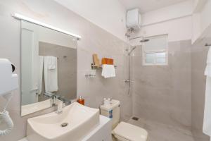 a white bathroom with a sink and a toilet at Villa Rosaria - Framed by Nature, Finished with Luxury in Beragala