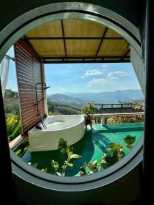 a bathroom with a tub and a swimming pool at สกายวิวคาเฟ่&โฮมสเตย์ in Ban San Pu Loei