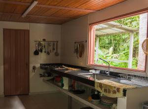 a kitchen with a sink and a window at casa Lucerna in Prado