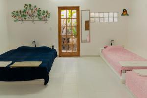 a room with two beds and a door with a window at casa Lucerna in Prado
