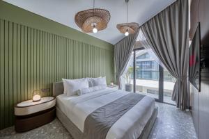 a bedroom with a large bed and a large window at Melasti Dream Residence in Uluwatu +85 photos