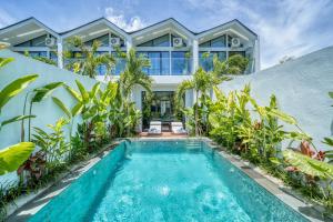 an exterior view of a house with a swimming pool at Melasti Dream Residence in Uluwatu