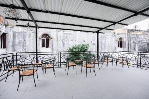 a group of tables and chairs in a building at Hotel 88 Batulicin by WH in Batulicin