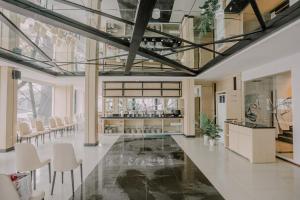 a lobby with a glass floor and white chairs at Hotel 88 Batulicin by WH in Batulicin