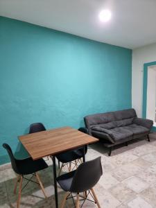 a living room with a couch and a table and chairs at Merida Centro House with Private Pool and Air Conditioning in Mérida