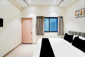 a bedroom with a large bed and a window at Collection O Shendra MIDC Aurangabad Formerly Sai Palace in Aurangabad +42 photos