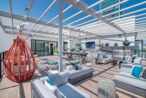 a living room with white couches and a swing at Volar Luxurious #328 in Los Angeles