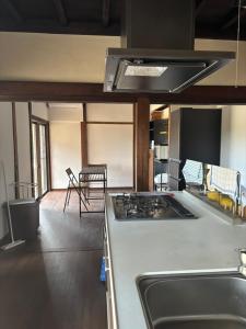 a kitchen with a stove and a counter top at Edo house in Shiigi