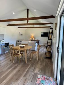 a dining room and living room with a table and chairs at The Grain Shed in Euroa