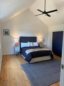 a bedroom with a bed and a ceiling fan at The Grain Shed in Euroa