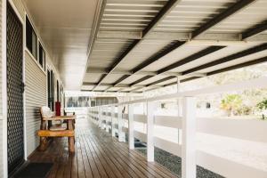 an empty porch with a chair and a table at The Moonie Crossroads Hotel in Moonie