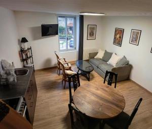 a living room with a table and a couch at Duplex vue sur château in Clisson