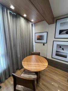 a dining room with a table and two chairs at Loft de Luxo com Charme e Design Moderno in Cuiabá