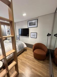 a bedroom with a bunk bed and a chair at Loft de Luxo com Charme e Design Moderno in Cuiabá
