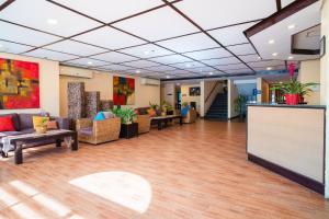 a lobby with couches and tables in a building at Microtel by Wyndham Cabanatuan in Cabanatuan