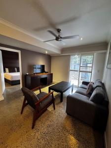 a living room with a couch and a bed at Sovereign Resort Hotel in Cooktown