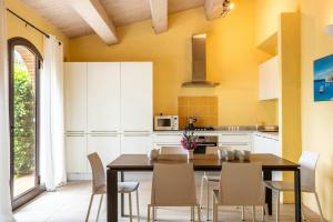 a kitchen with a dining room table and chairs at Historic Farmhouse Between Two Tuscan Valleys in Trequanda