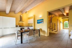 a kitchen and dining room with a table and chairs at Historic Farmhouse Between Two Tuscan Valleys in Trequanda +31 photos