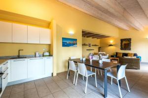 a kitchen and dining room with a table and chairs at Historic Farmhouse Between Two Tuscan Valleys in Trequanda