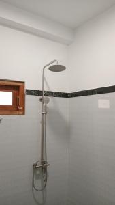 a shower with a glass door in a bathroom at The White Crane Koggala in Habaraduwa Central +62 photos