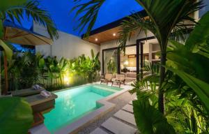 a swimming pool in the middle of a house at Atol Villas in Uluwatu