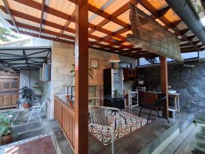 an outdoor kitchen with a wooden pergola at rumah566 in Yogyakarta
