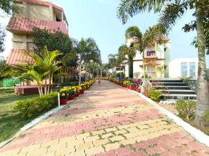 a brick walkway in front of a building at Mayabon Resort Bolpur in Shānti Niketan +57 photos