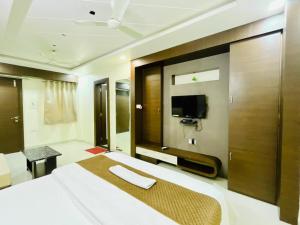 a hotel room with a bed and a tv at Lijoy Hotel & Restra in Būndi